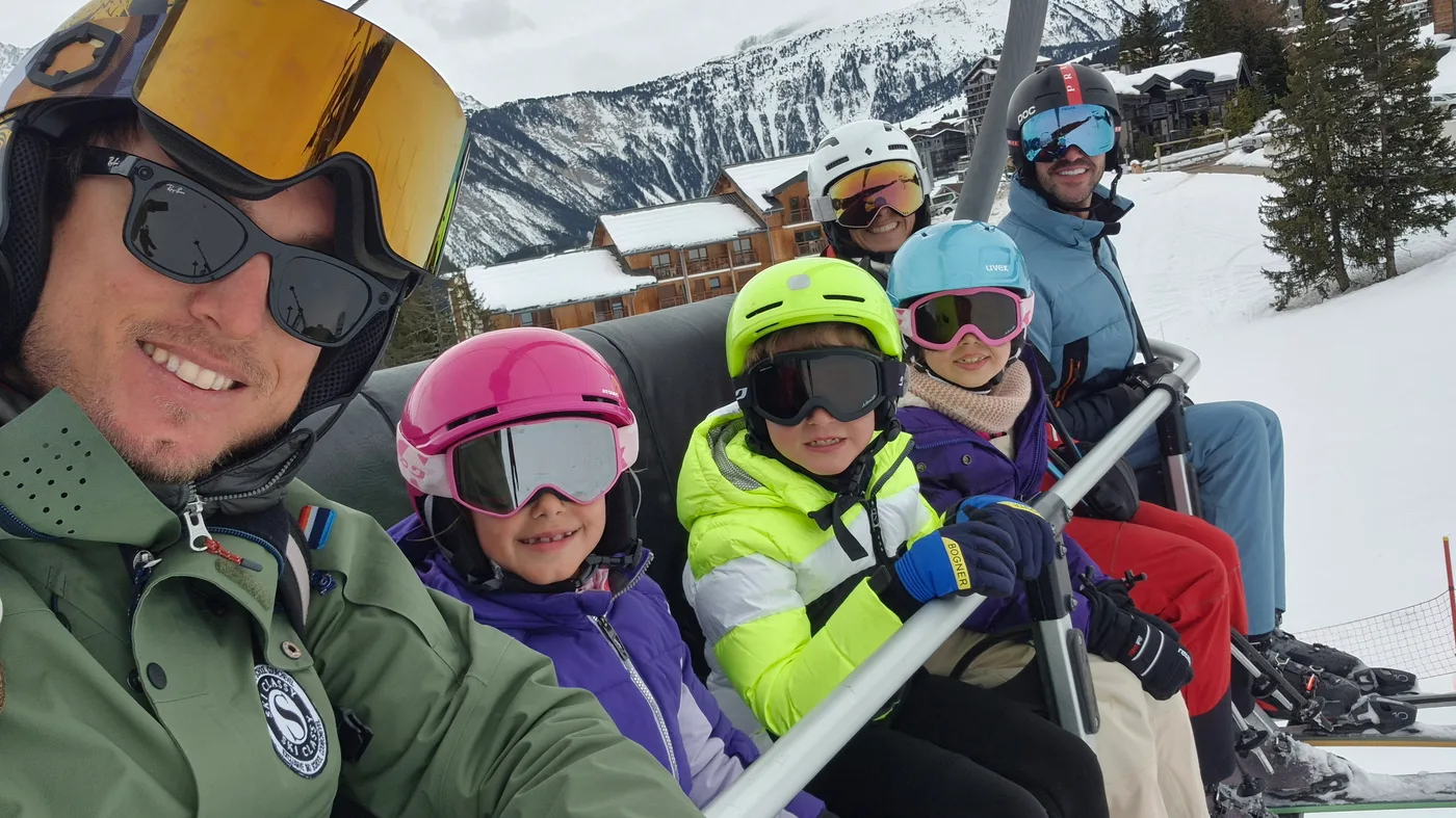 Skiers and children together on a chairlift